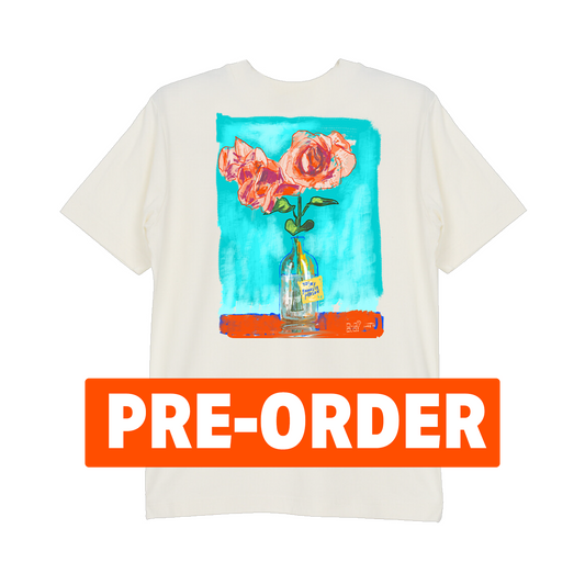 White t-shirt with floral design and 'PRE-ORDER' label on a white background